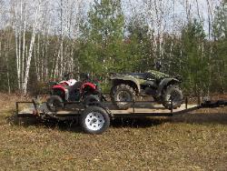 Use as a utility trailer, this one has three 4 wheelers.