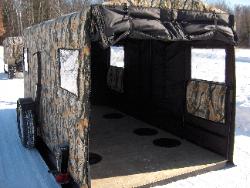 The back door rolls up easily and secures to the top. This Trailer has six fishing holes installed.